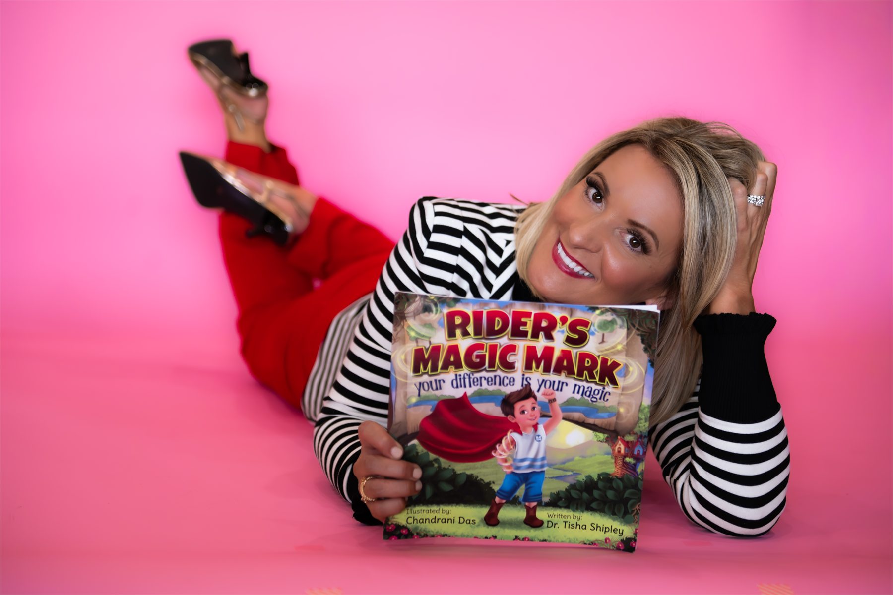 Dr. Tisha Shipley with the Rider puppet and Rider's Magic Mark book